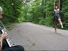 Laurana Wong & Gerald Stephens - Improvisation for Two - A road stretches back into the woods; A gentleman plays a tiny piano with his mouth, and she reaches skyward with joy, her leg kicking into an upward leap
